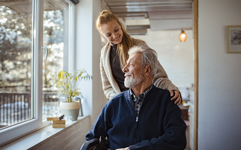 Woman caring for an elderly man