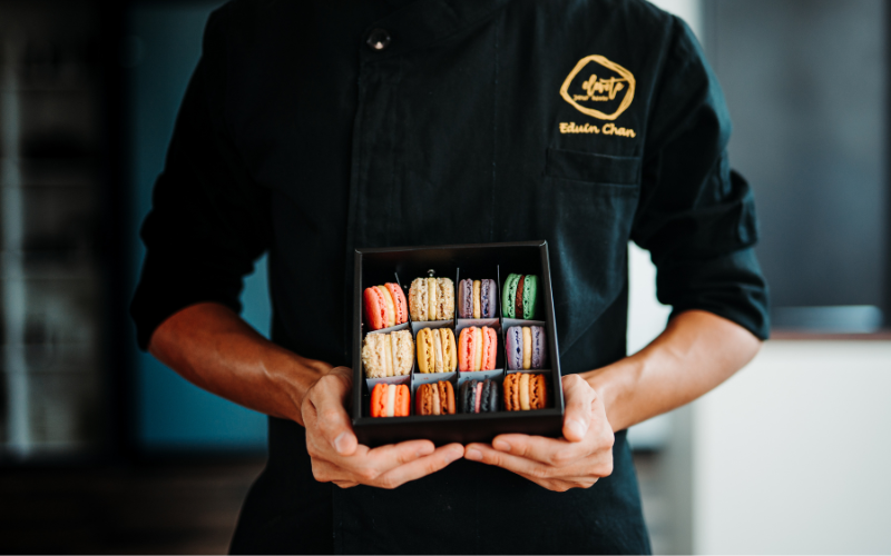 Edwin holding a box of macaroons