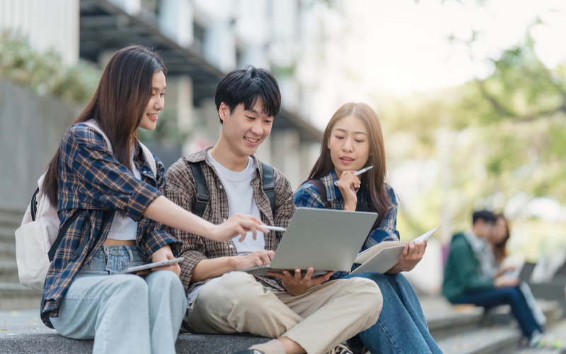 group of college students sitting and discussing