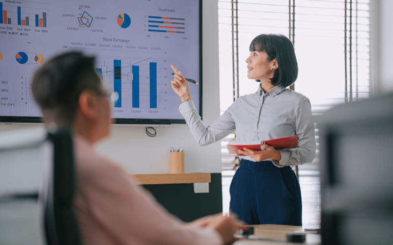 woman confidently presenting to colleague