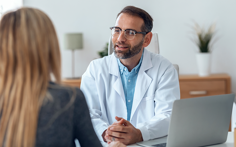 Male doctor explaining to female patient