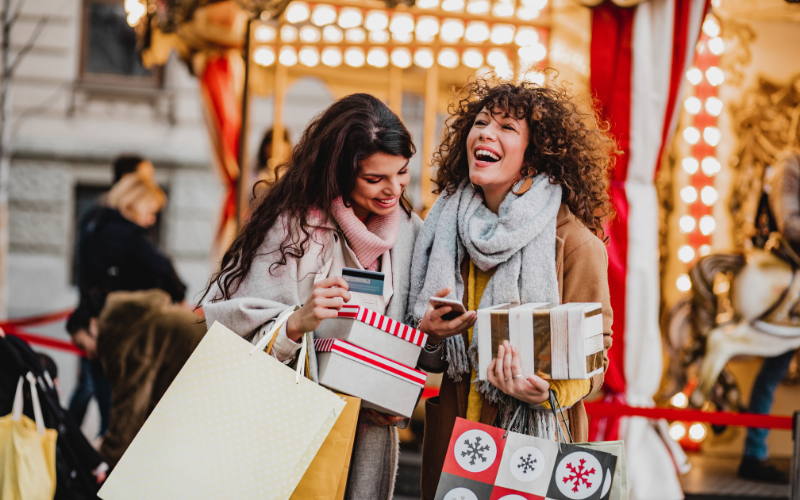 Women carrying Christmas gifts and gift bags