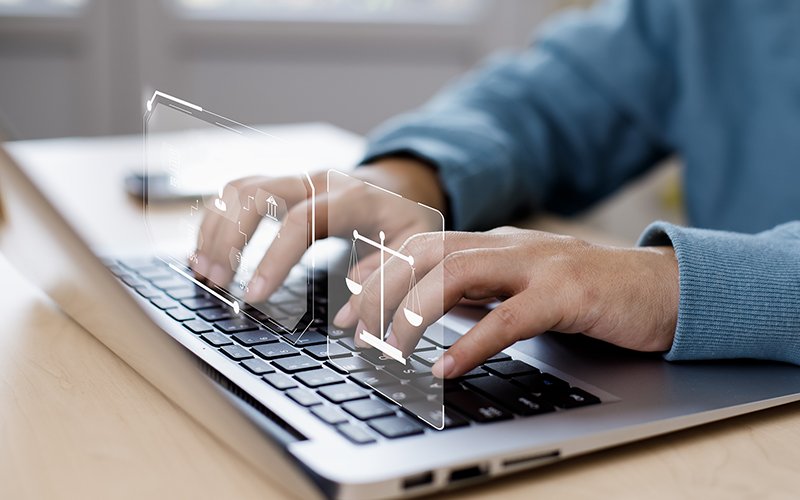 Hands typing on laptop searching for online legal service 