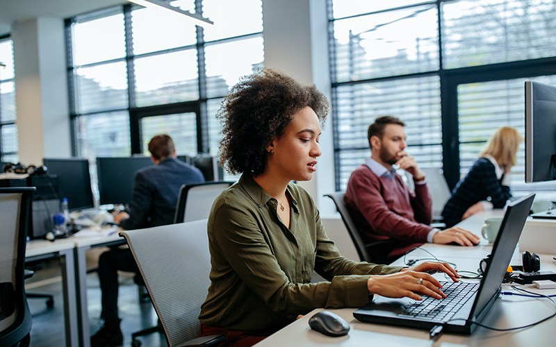 Female employee working on her laptop in an office