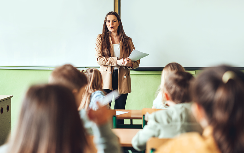 Female teacher conducting a lesson in a class