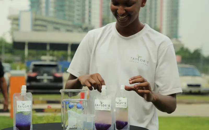 Bachelor of Science (Honours) in Architecture student and volunteer Omar Osman showcasing a drink made from ingredients harvested from Taylor’s Urban Farm