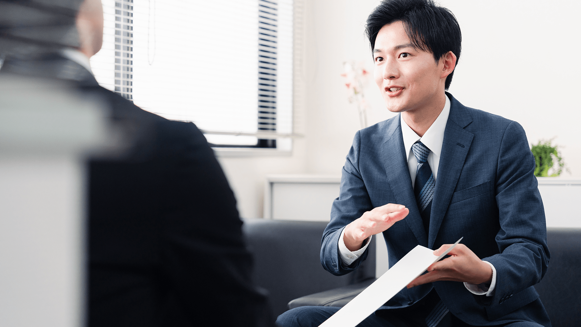 Young businessman presenting documents at a business meeting