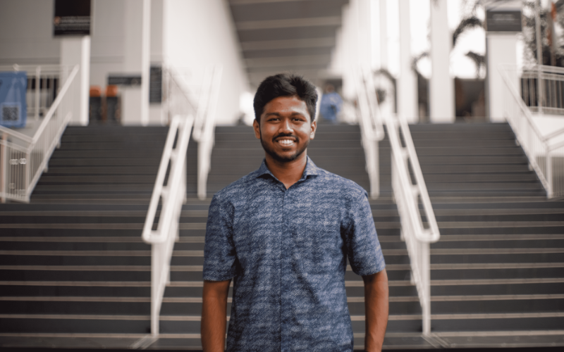 kishen standing in front of taylors stairs