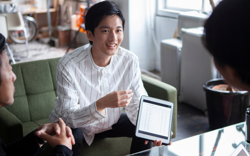 Student showing the report to the industry client