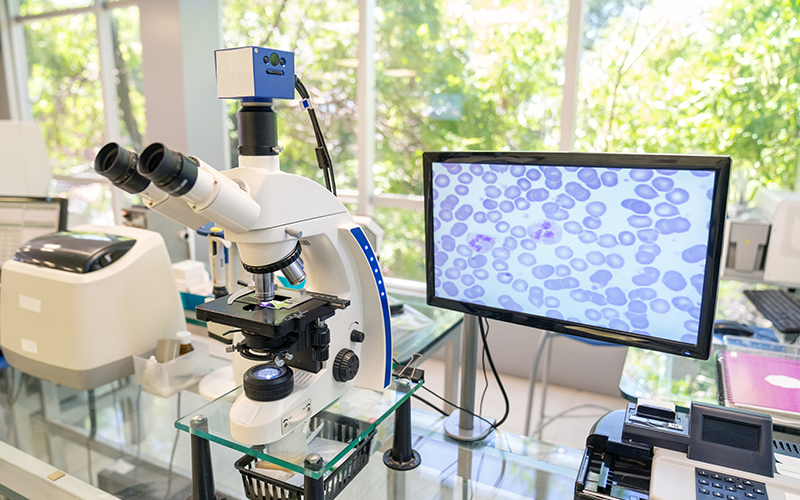 Modern microscope equipped with a digital camera, computer and monitor in a biological research laboratory