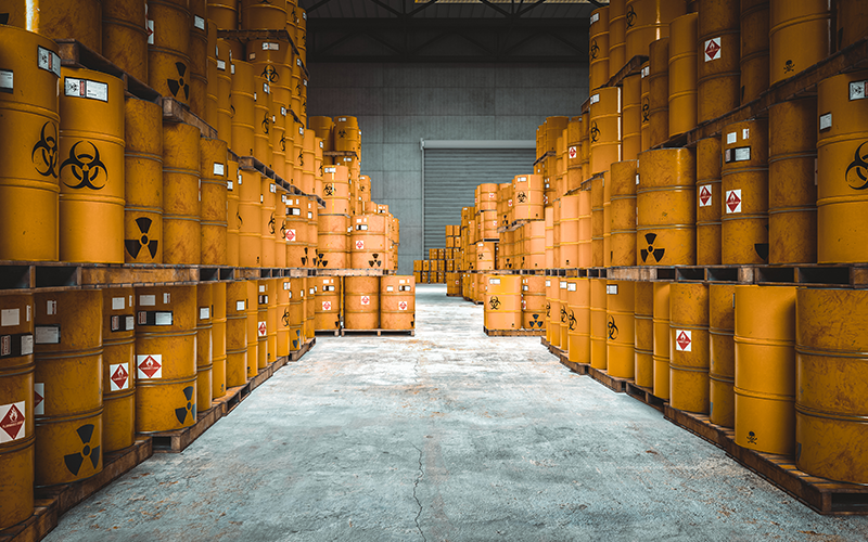 Storage of yellow bins with radioactive and chemical hazard symbol