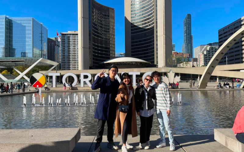 students posing in front of toronto sign