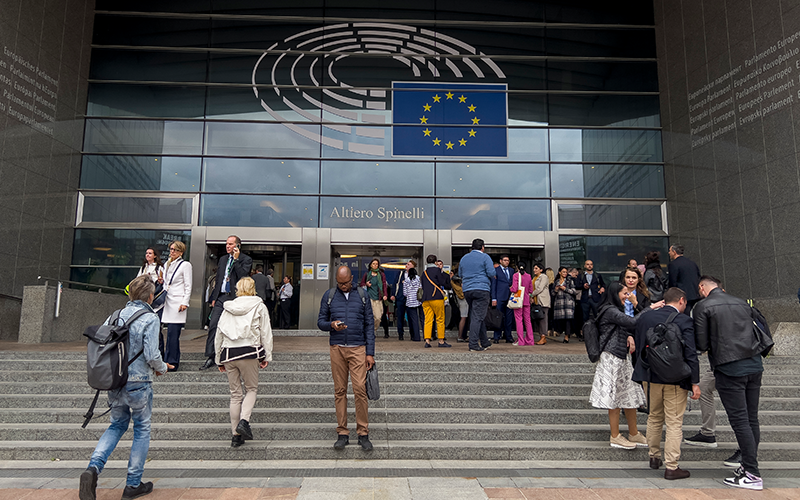 People walk outside of the European Parliament in Brussels, Belgium
