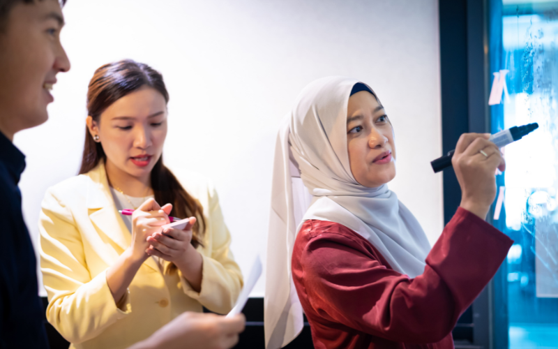 malay woman writing on a board