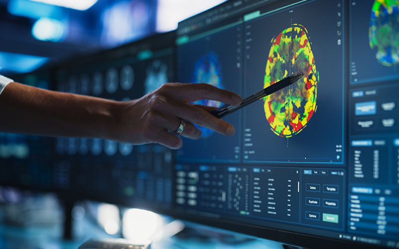 Modern Medical Research Center: Anonymous Doctor Pointing At Desktop Computer Monitor With CT Scan Of Human Spinal Cord