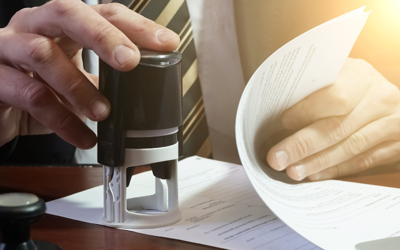 Businessman puts a stamp on contract