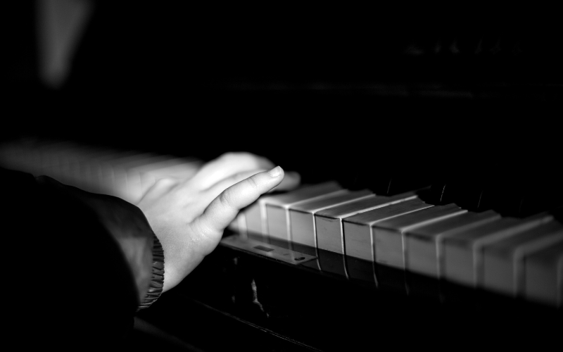 Child's hand on piano keys