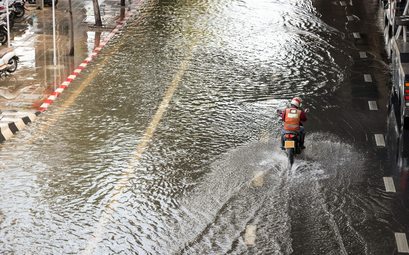 motorbike wading through a mini flood