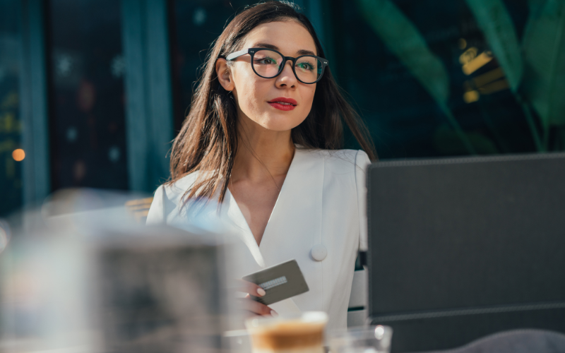 Businesswoman in white dress shirt looking at the computer screen