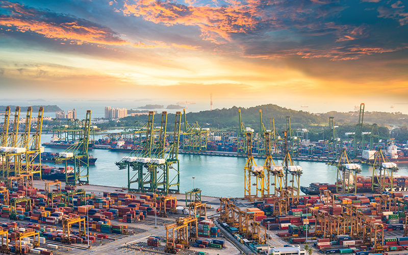 Container Cargo freight ship with working crane bridge in shipyard in singapore