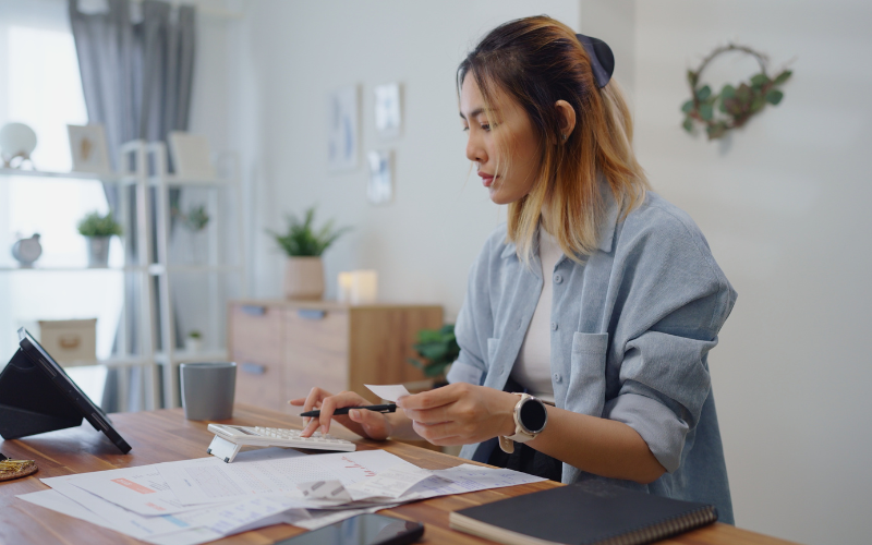 woman doing her finances with a calculator