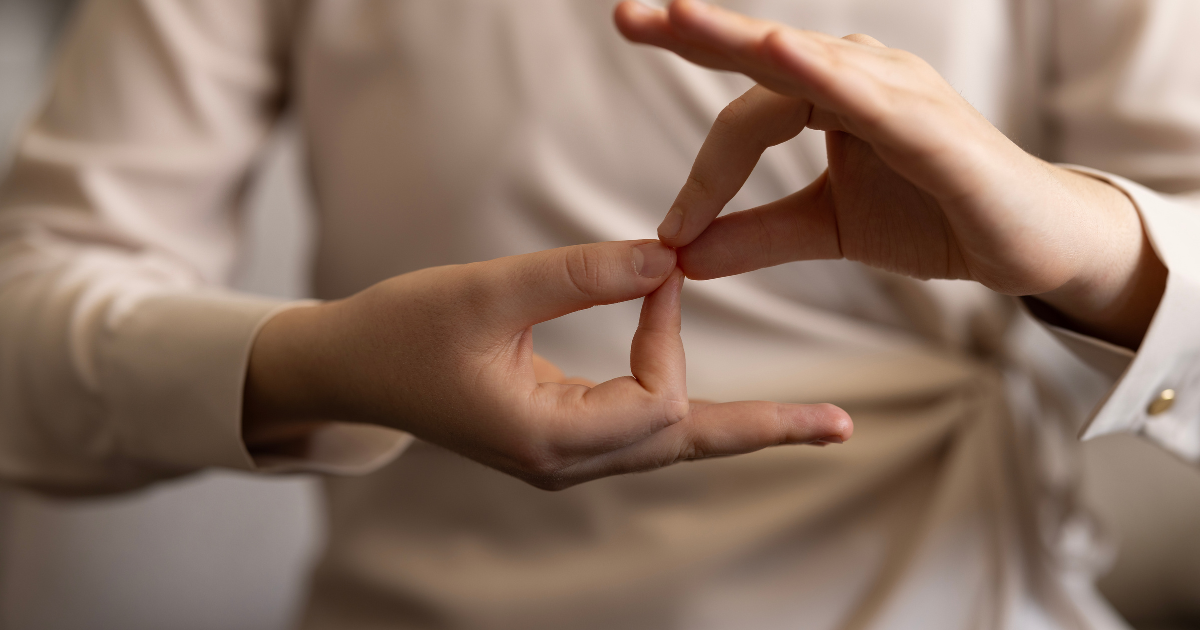 Close-up of hands forming the American Sign Language (ASL) sign for 'interpreter'