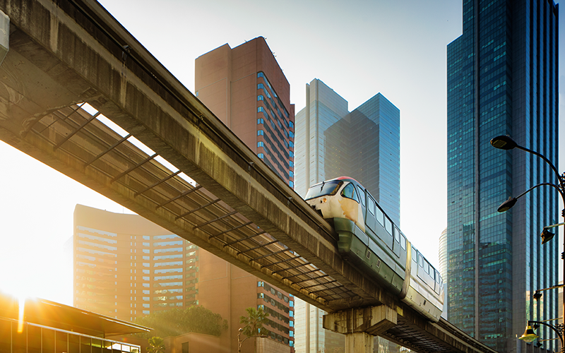 Kuala Lumpur elevated Monorail in Chow Kit back lit by sunrise