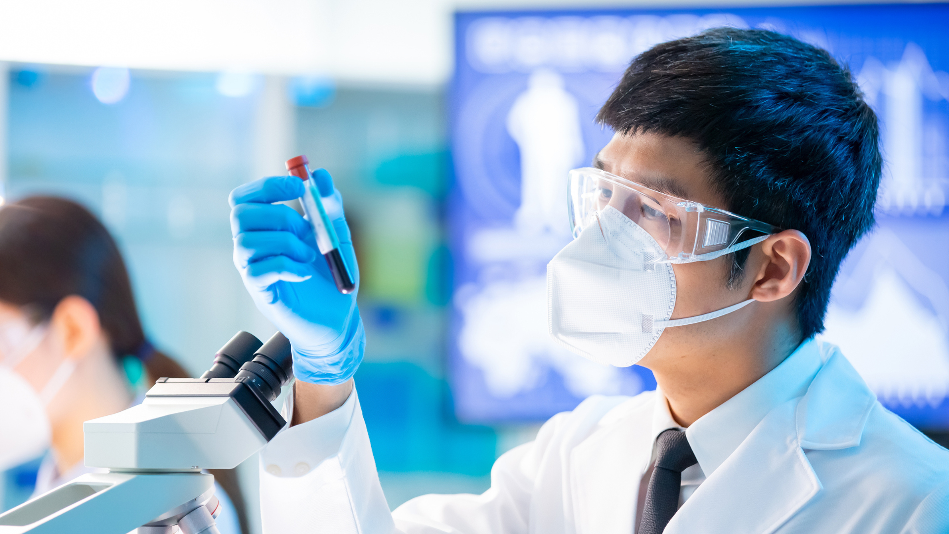 man holding up a test tube