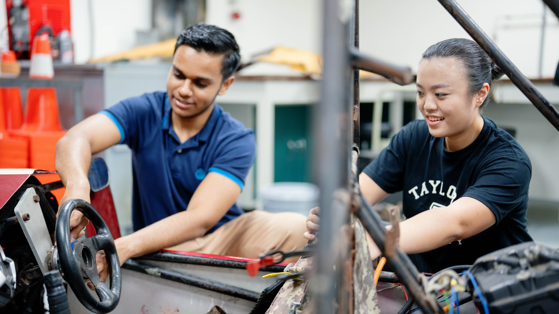 students working on a car
