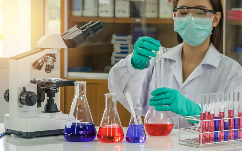 woman experimenting with differnent coloured chemicals