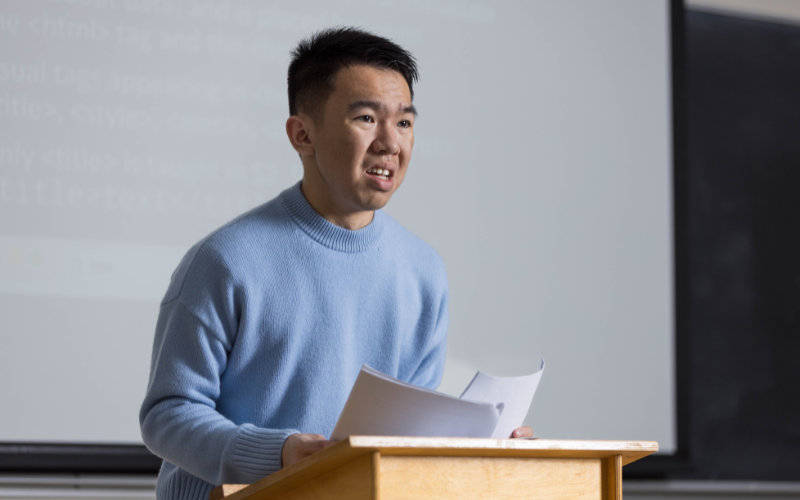 man giving a speech on a podium