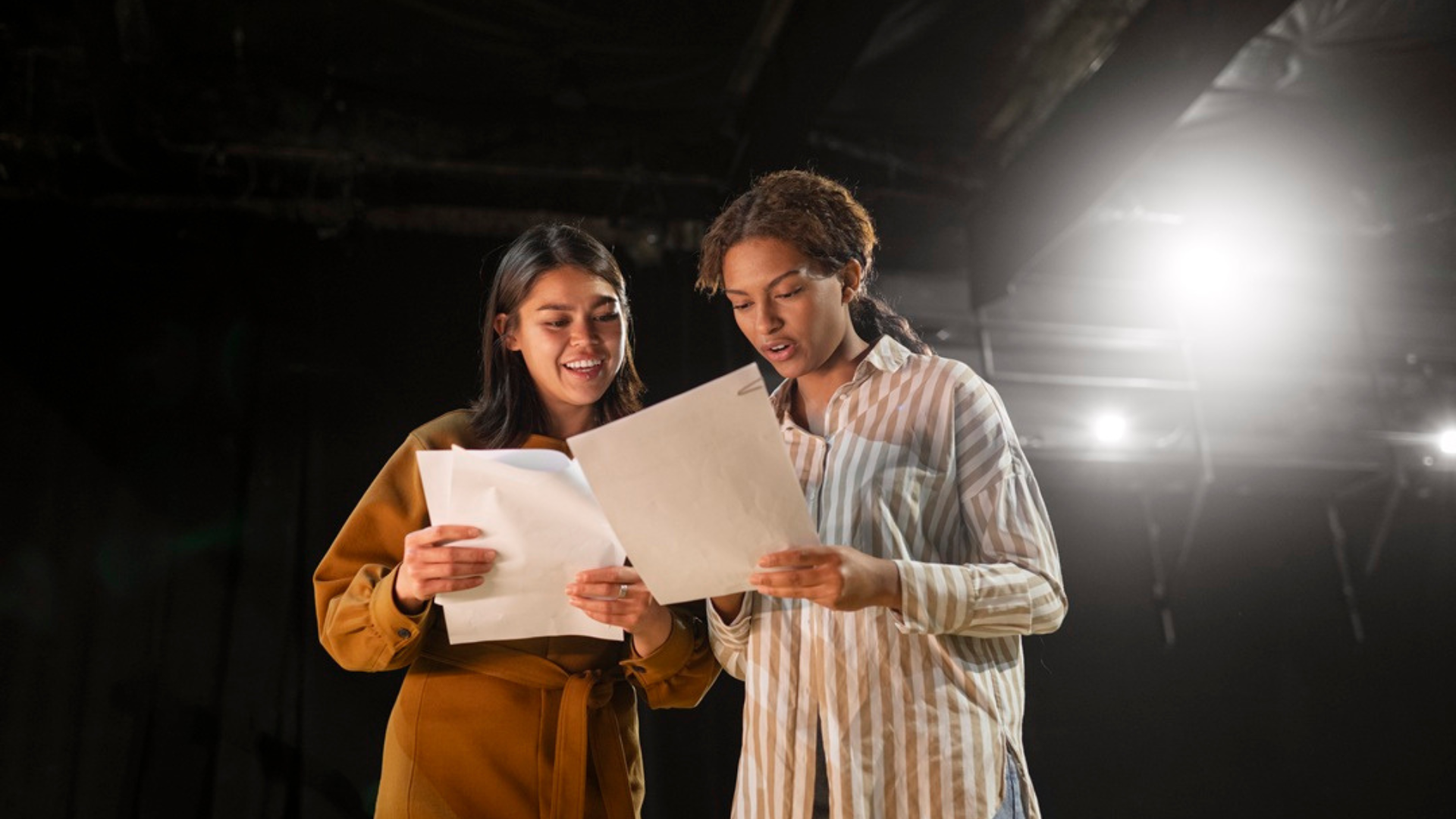 students reading a script on stage
