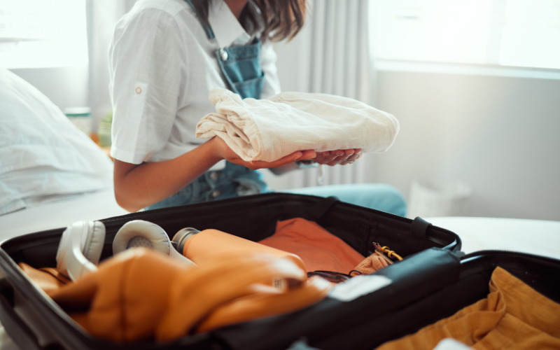 A woman packing a suitcase