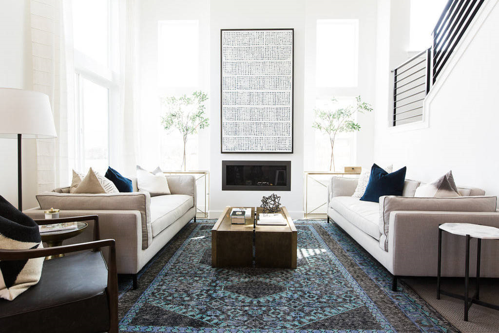 Modern minimalist living room with symmetrical sofas and a bold art focal point