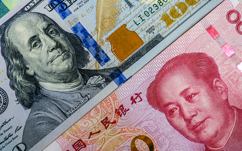 Face to face of US dollar banknote and China Yuan banknote for 2 biggest economic in the world which now United states of America and China have war trade.