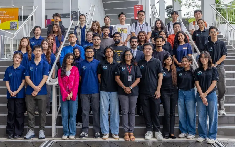 Members of the PATA Malaysia Taylor's Student Chapter in matching polo shirts, standing together on a campus staircase