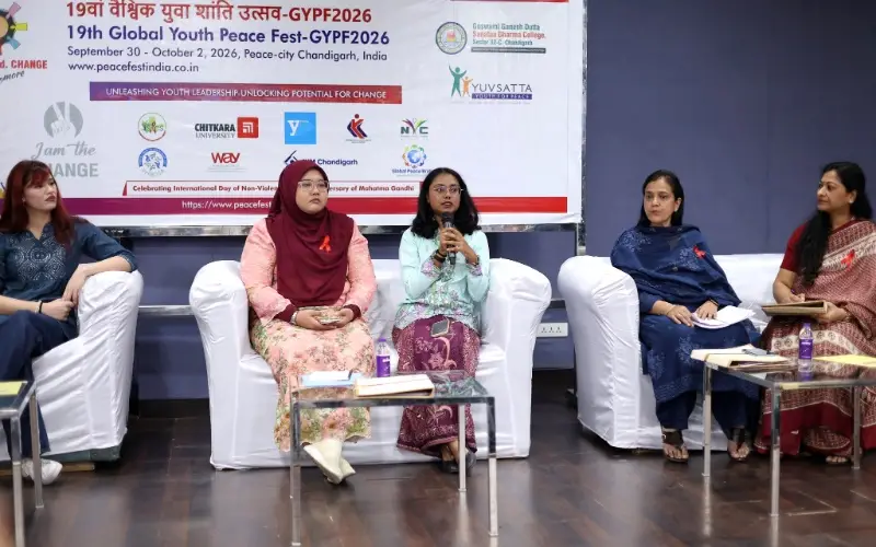 Mirsha Naresh Kumar speaks into a microphone while seated with four other participants during a festival panel on gender equality and girls' leadership