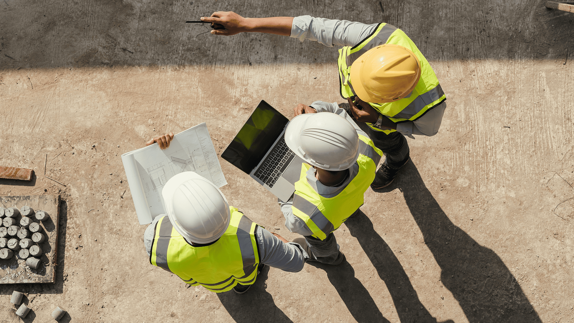 Top view, Team engineer building inspection use tablet computer and blueprint working at construction site.