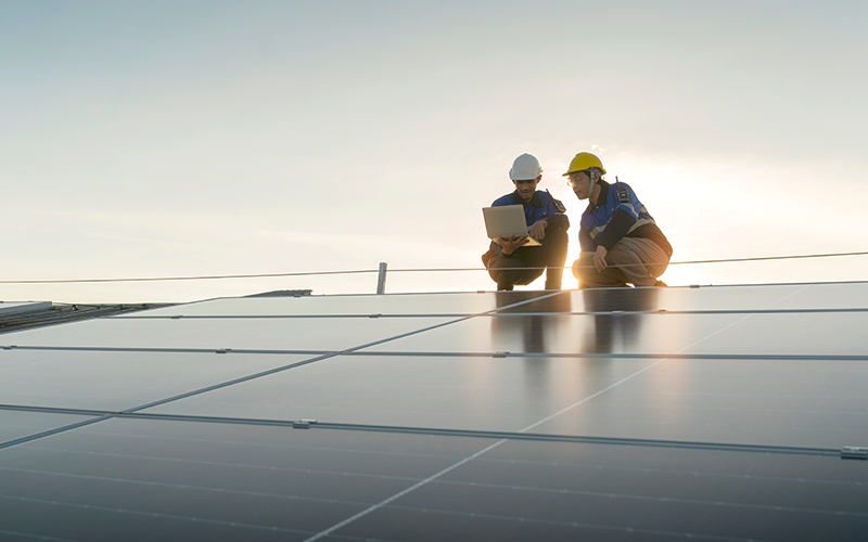 Engineer at the roof examining solar cell