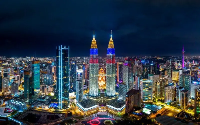 Kuala Lumpur city skyline at night with the Petronas Twin Towers lit up
