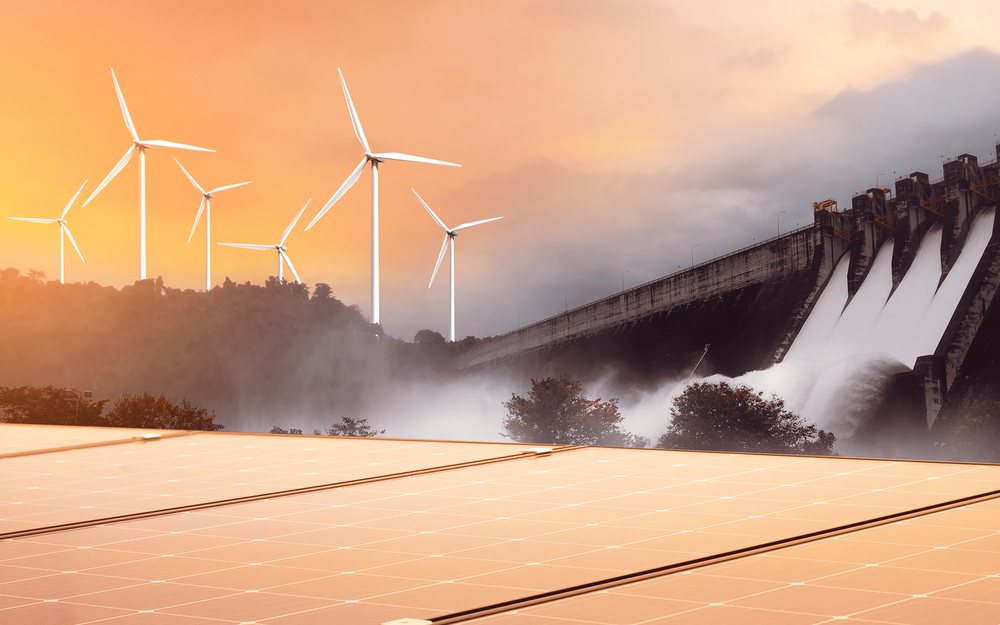 Wind turbines and a hydroelectric dam above a field of solar panels at sunset