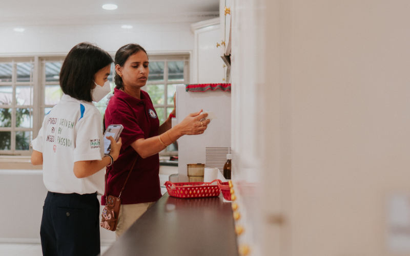 Taylor's pharmacy student and a pharmacist at a community health screening counter