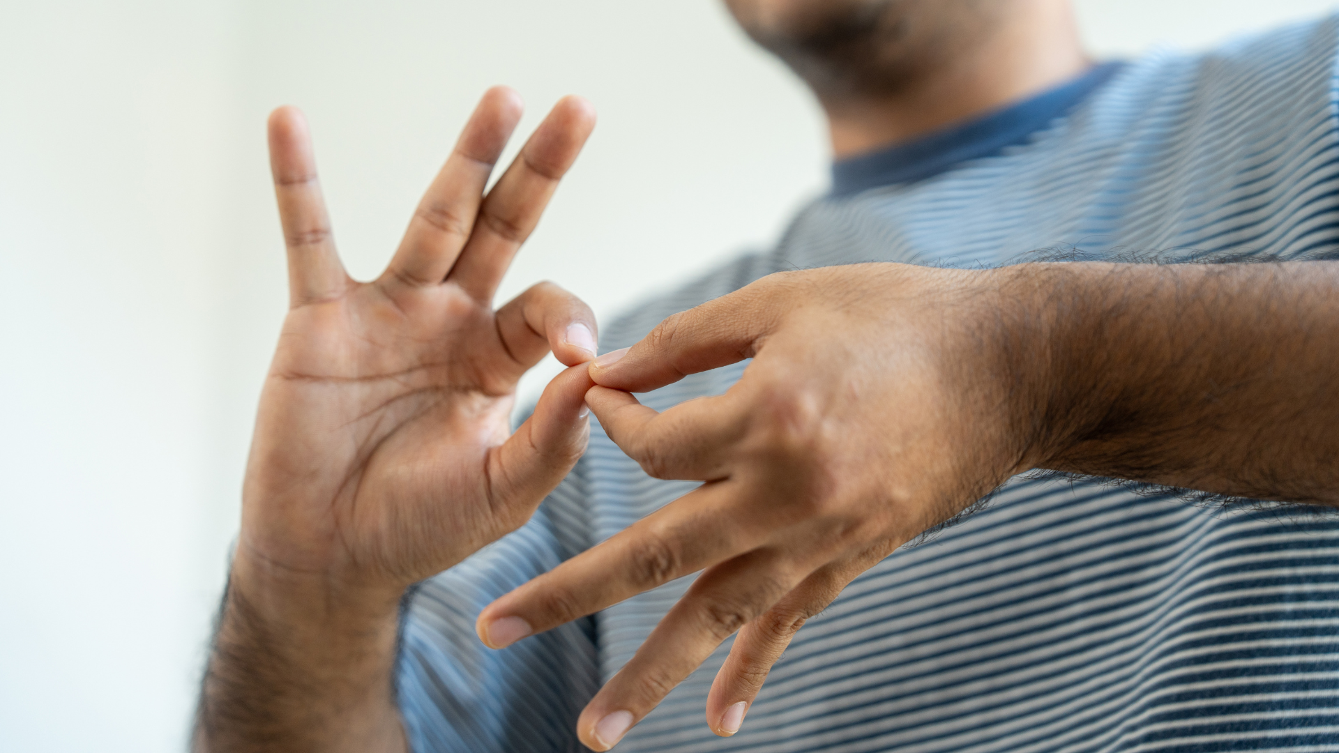 A person using sign language, hands forming a gesture