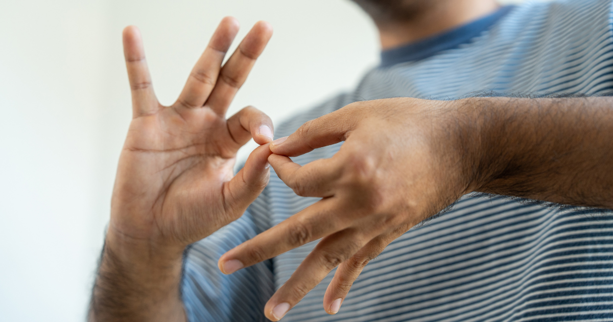 A person using sign language, hands forming a gesture