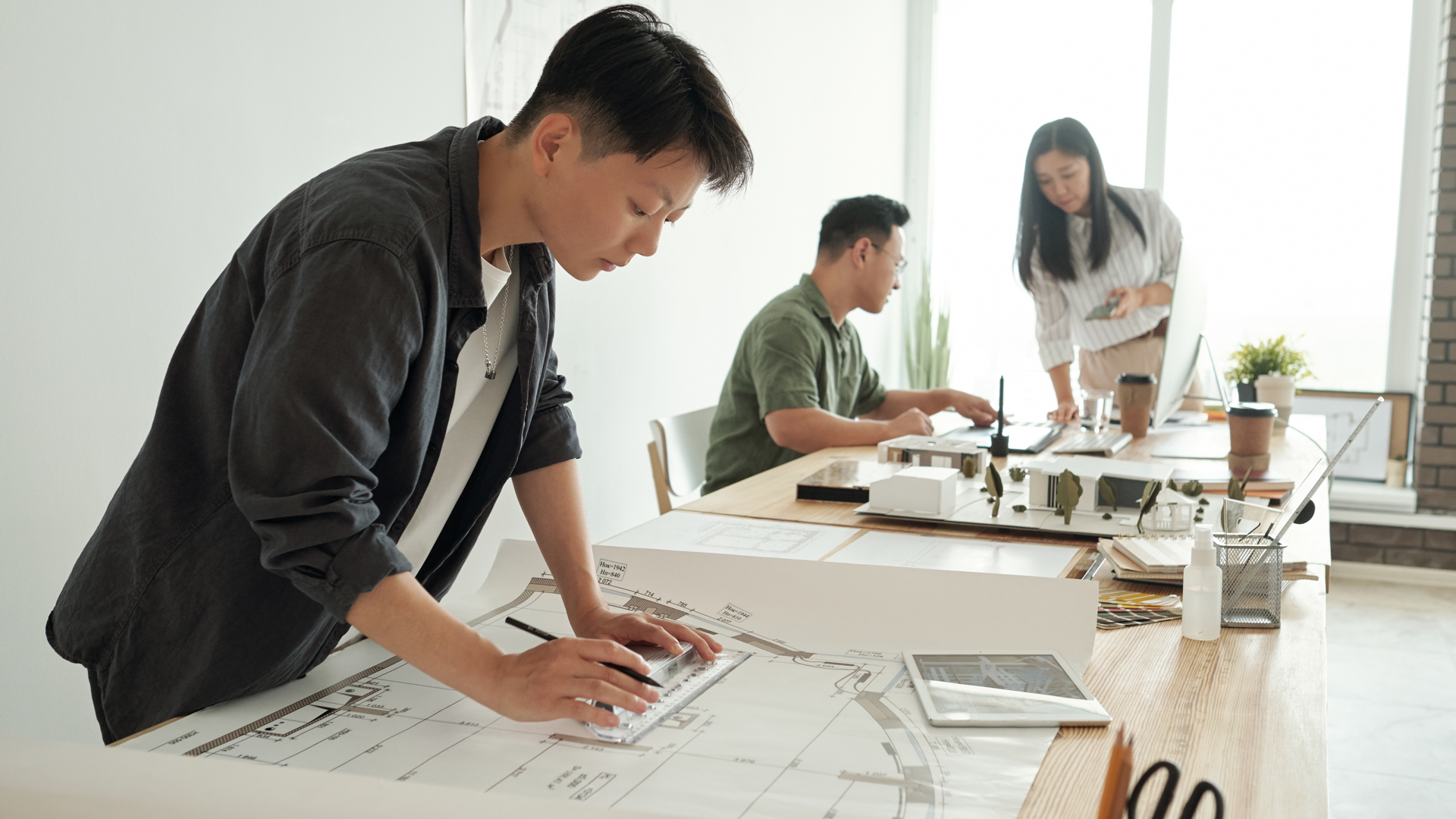 Taylor’s architecture researcher working on design plans for a project
