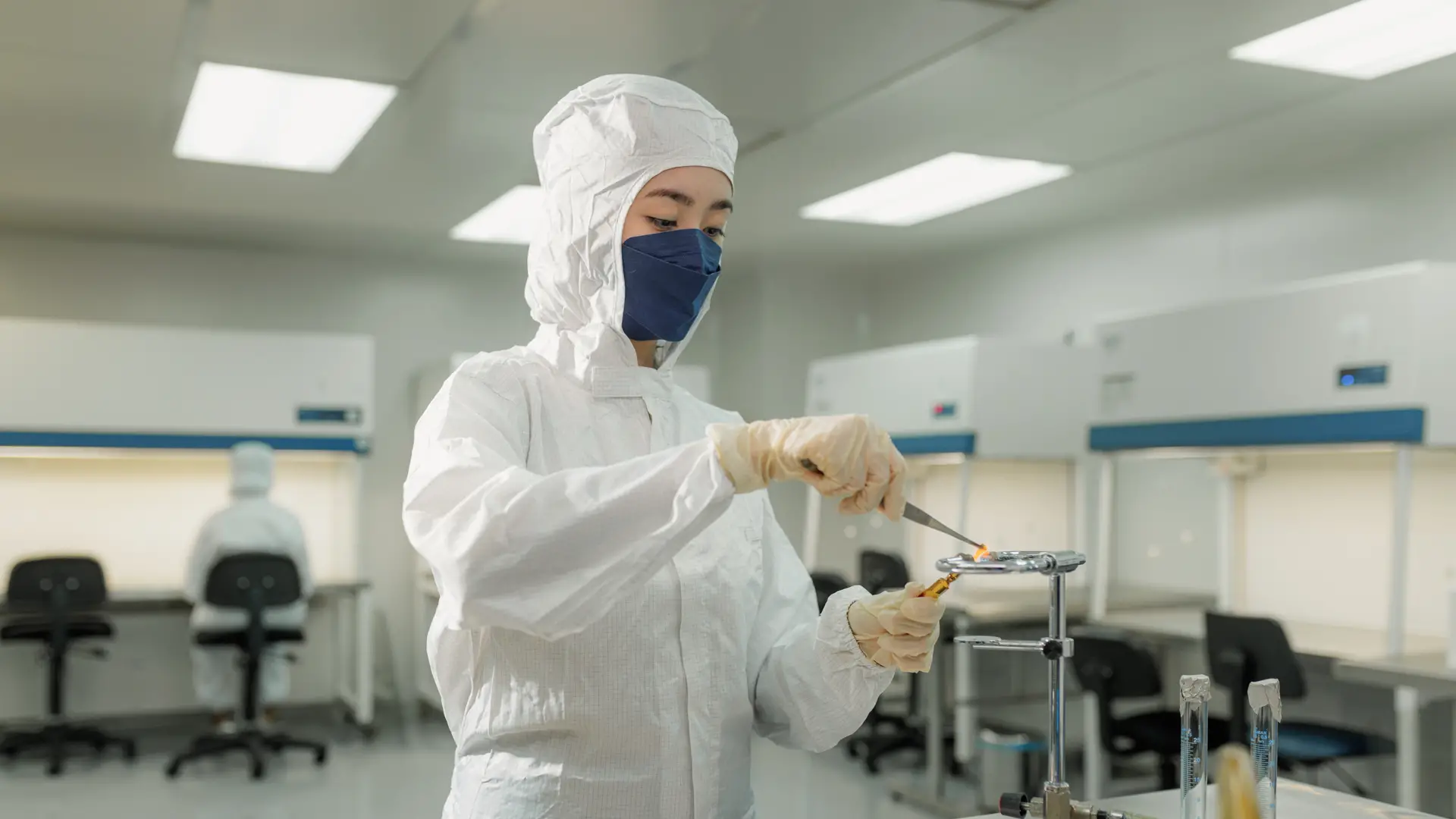 PhD in Science student conducting advanced laboratory research in a cleanroom environment