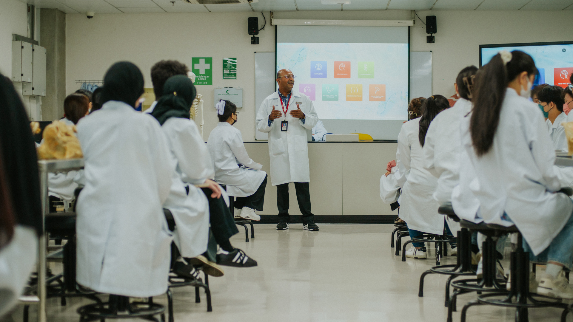 Biotechnology lecturer teaching students in a laboratory classroom setting