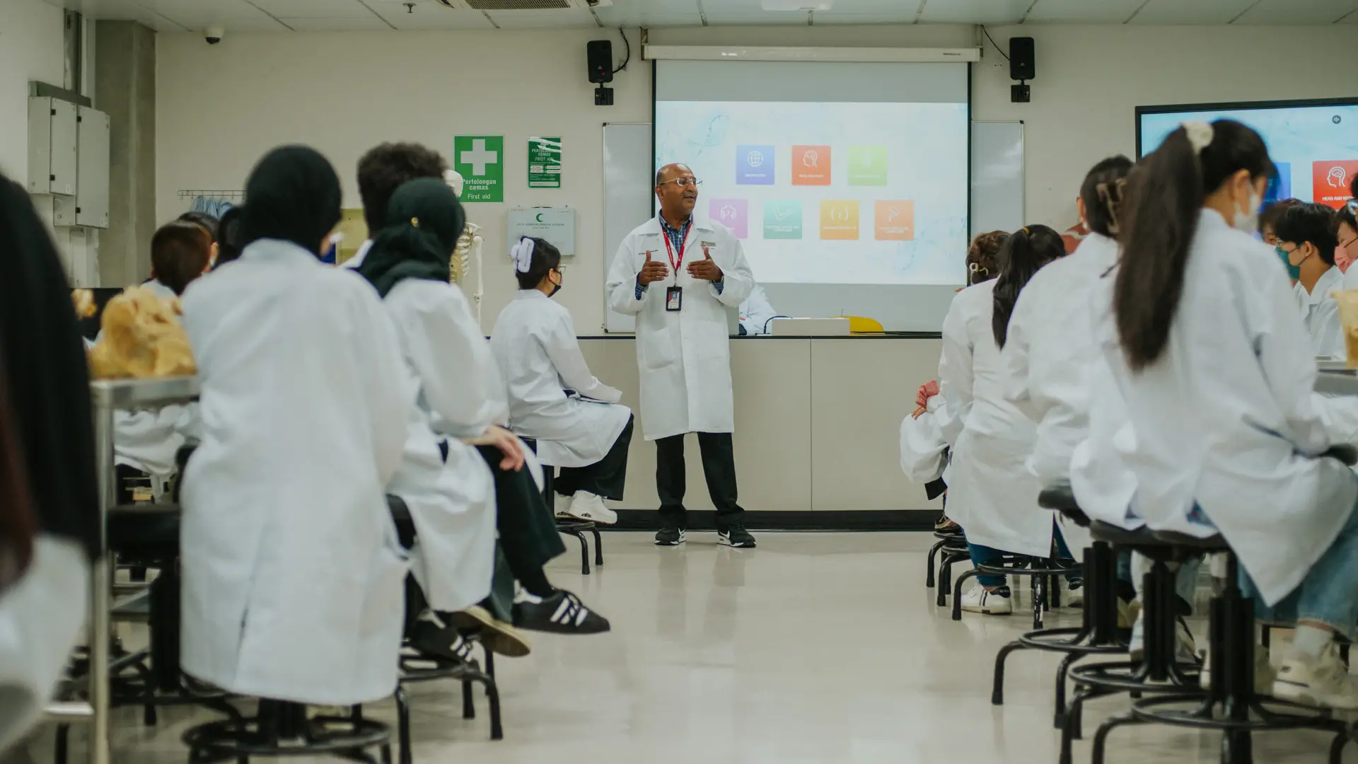 Biotechnology lecturer teaching students in a laboratory classroom setting