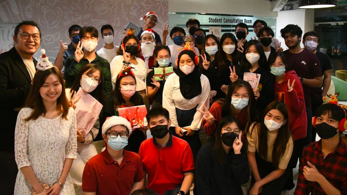 Group of students taking photos in front of the office