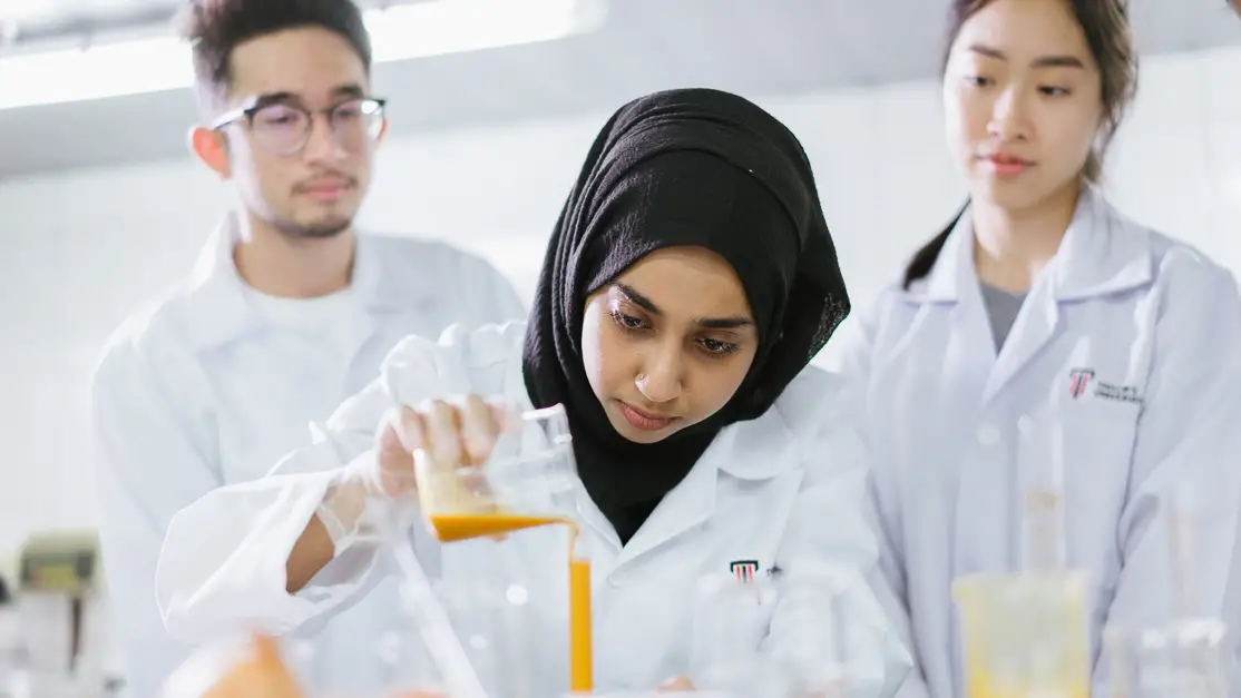 Taylor's bioscience student working with peers in the laboratory